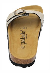 Sandalo con plantare in sughero beige, dotato di una cinghia testurizzata e fibbia metallica regolabile, con suola in gomma nera e logo del marchio visibile.