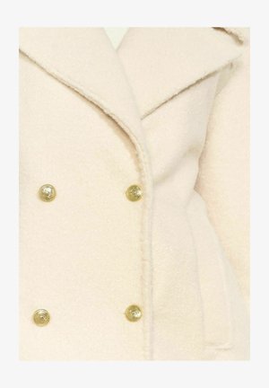 Kahetisõrmeline mantel pehmest, heledast beežist kangast, millel on kuldse tooniga nööbid ja sälguga krae. Tekstuur näib olevat udune ja soe.