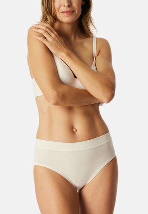 Lightweight, cream-colored bra with soft fabric and thin straps, paired with matching high-waisted briefs featuring a smooth waistband.