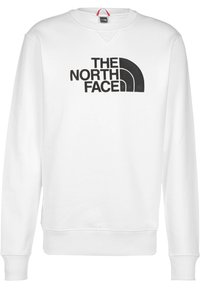Sudadera blanca de algodón, con una impresión gráfica negra de "THE NORTH FACE" y un logo curvado. Puños y dobladillo de canalé.