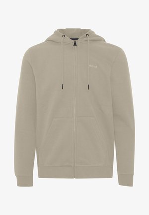 Hanorac crem cu fermoar, realizat dintr-un material moale, având glugă reglabilă cu șnururi, buzunare frontale spațioase și un detaliu discret cu logo pe piept.