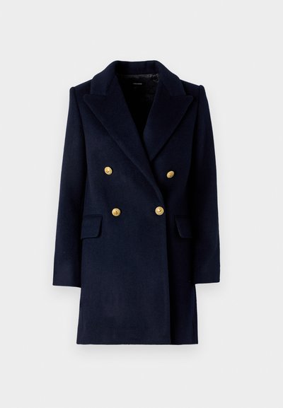 Merine sinine topelt-kinnitatud mantel, millel on sakilise krae, kuldsed nööbid ja ees olevad taskud. Valmistatud tekstureeritud villasegust.