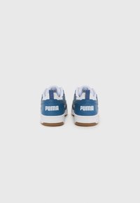 Blue leather sneakers with white accents and a gum sole. Features a prominent white "PUMA" logo on the heel and a padded collar.