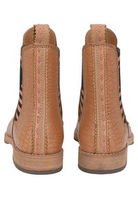 Tan leather ankle boots with black fabric panels, embossed texture, pink stitching along the back seam, and a brown wooden sole.