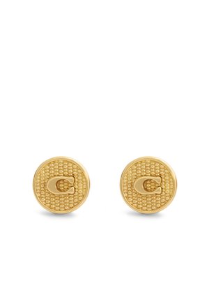 Boucles d'oreilles clous rondes ton or avec motif texturé et logo C en relief au centre sur fond blanc.