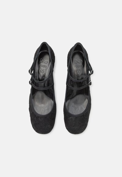 Black ballet flats with a textured pattern, adjustable straps, rounded toe, and smooth interior. Lightweight design suitable for casual wear.