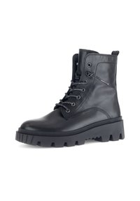 Bottines en cuir noir à semelle épaisse, à bout rond, à lacets sur le devant et avec œillets en métal. Accents texturés et languette à l'arrière.