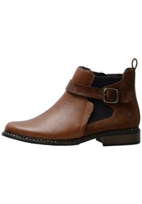 Stivale ankle in pelle marrone con pannelli elastici laterali, una fascia decorativa con fibbia metallica e un tacco basso impilato. Dettagli cuciti.