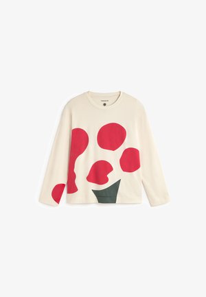 Beige pitkähihaisen topin edessä on suuria punaisia ja vihreitä abstrakteja muotoja. Pehmeästä puuvillakankaasta valmistettu, pyöreä kaula-aukko ja rento istuvuus.