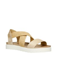 Sandali beige con cinturini incrociati in materiale intrecciato e pelle liscia, posti su una suola spessa bianca e dal design piatto.