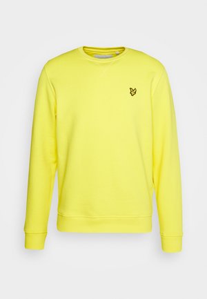 Sweat-shirt jaune à col rond, à manches longues et avec des poignets côtelés. Présente un petit logo brodé en noir. Texture du tissu lisse.