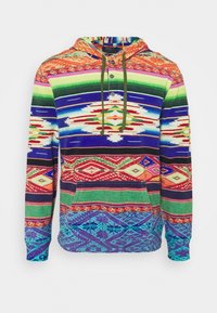Kapuzensweatshirt mit Fronttasche, Knopfleiste, grünen Kordeln und lebhaften, mehrfarbigen geometrischen und tribalem Mustern.
