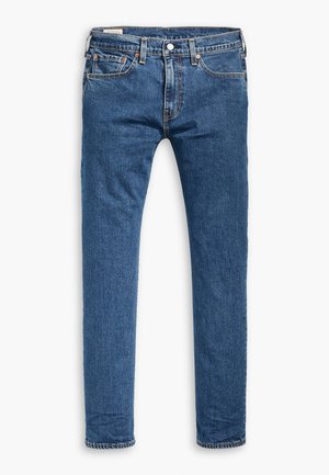 Blue denim jeans with a slim fit, featuring a button closure, five pockets, and contrasting stitching along the seams and hem.