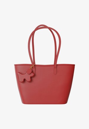 Red tote bag made from textured material with two handles. Features a dog-shaped charm in matching red, attached by a gold-colored clasp.