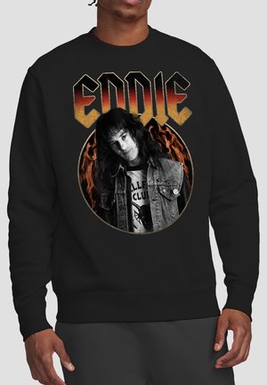 Black sweatshirt with "EDDIE" text above a grayscale portrait of a long-haired person in a denim vest against a flaming background.