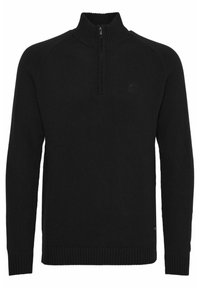 Crna pletena veste s visokim ovratnikom i patentnim zatvaračem do četvrtine. Ima rebraste manžete i rub, glatku teksturu te mali logo na prsima.