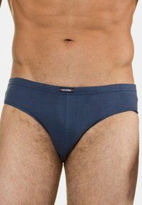 Laivaston siniset miesten alushousut, jotka on valmistettu pehmeästä kankaasta. Ne sisältävät logolla varustetun vyötärönauhan, jossa on hillitty kuvio ja sileä rakenne.