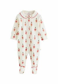 Weißer Baby-Overall mit wiederholtem Nussknacker-Muster in Rot und Braun. Verfügt über einen Kragen mit roter Umrandung und Druckknöpfen vorne.