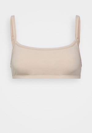 Beige saumatun bralette, jossa on neliön muotoinen kaula-aukko, ohuet säädettävät olkaimet ja sileä, joustava kangas. Minimalistinen muotoilu ilman kiinnityksiä.