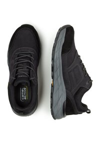 Black athletic shoes made of suede and mesh, featuring a gray rubber sole, lace-up design, and yellow accent on the heel.