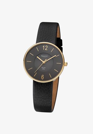 Montre-bracelet à bracelet en cuir noir avec boîtier en or, index des heures en or et aiguilles indiquant 10:10:37, étiquetée "Regent Solar Vegan".