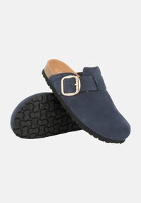 Zoccoli in suede blu navy con fibbia metallica, soletta in sughero e suola in gomma nera testurizzata. Design con punta aperta e stile senza tallone.
