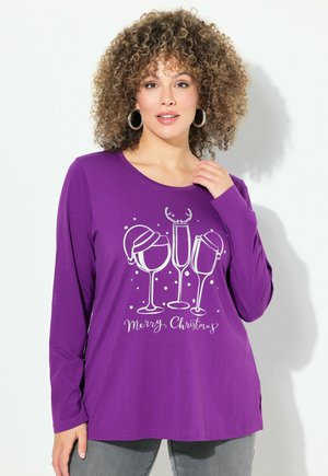 Paarse longsleeve shirt met een graphic van drie wijnglazen, sneeuwaccenten en de tekst "Vrolijk Kerstfeest" in het wit. Zacht materiaal, losse pasvorm.
