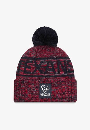 Knitted beanie in red and navy with a black pom-pom on top. Features "TEXANS" woven into the design and a logo patch on the cuff.