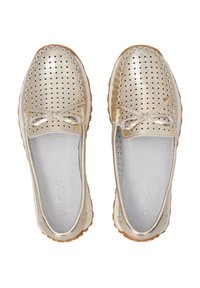 Gold metallic slip-on shoes with perforated design, scalloped edges, and a bow detail on the upper. Treaded rubber sole and soft lining.