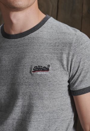 Gray short-sleeve T-shirt with dark gray ribbed collar, featuring embroidered "Superdry" logo in red and black on the chest. Cotton blend fabric.