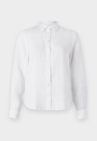 Camicia bianca in lino a maniche lunghe con bottone frontale, colletto e vestibilità leggermente rilassata. Tessuto testurizzato con leggeri segni di pieghe.