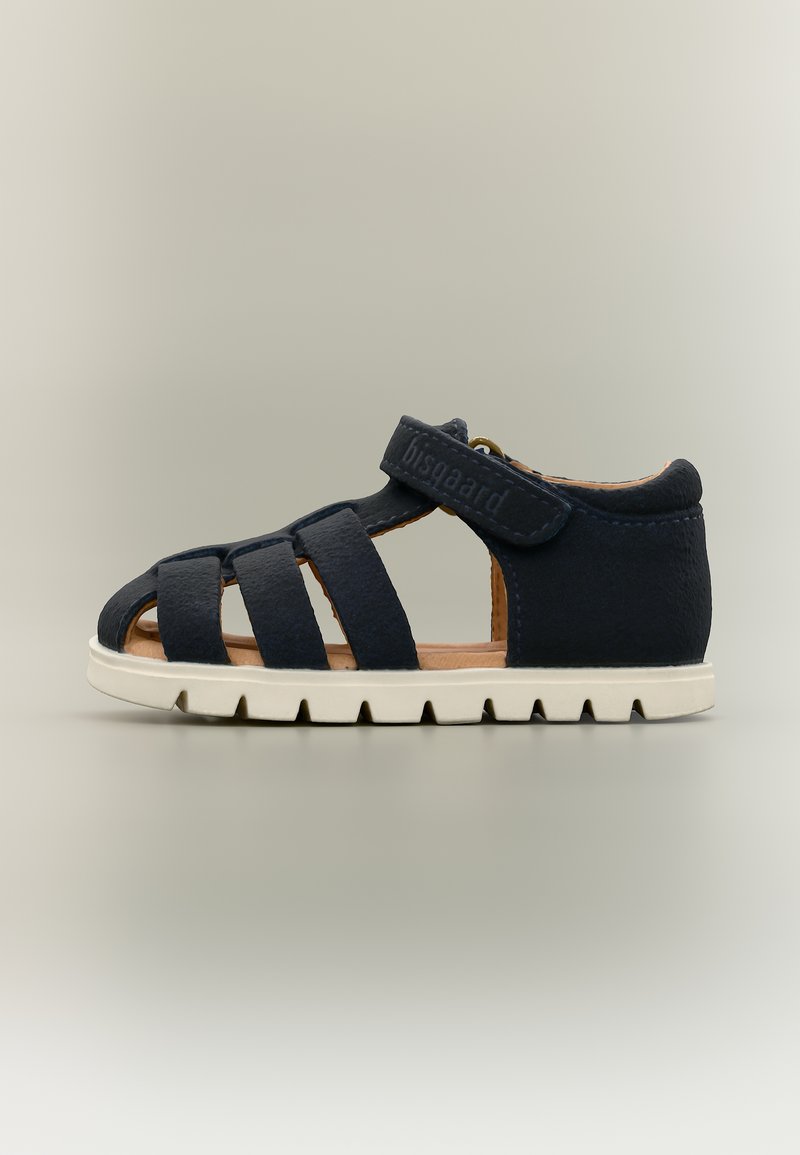 Sandale pour tout-petit bleu marine avec plusieurs brides à l'avant, fermeture à scratch autour de la cheville, intérieur beige et semelle épaisse blanche sur fond neutre.