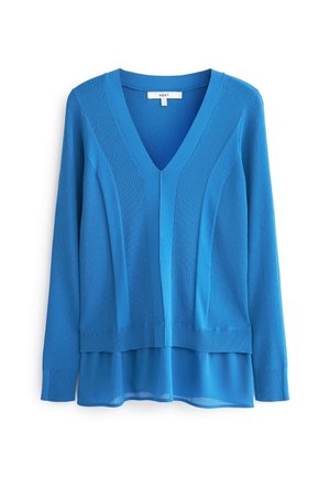 Pull bleu à manches longues avec col en V, motif en maille côtelée et empiècement en tissu transparent à l'ourlet, étiquette « NEXT » à l’intérieur du col.