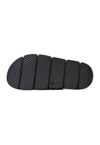 Black slide sandal sole, textured with a diamond pattern, features five sections and rounded toe. Made of durable rubber material.