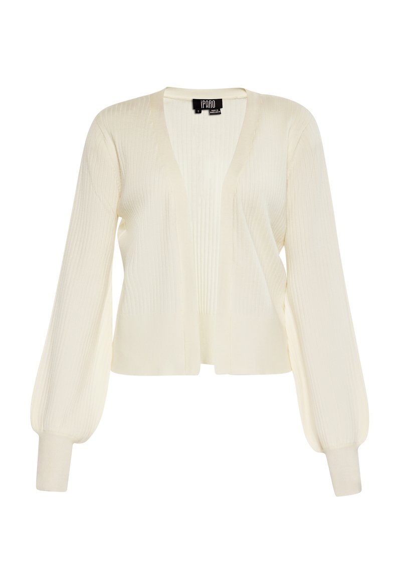 Cardigan de culoare crem, cu textură ribbed, design deschis în față, mâneci lungi cu volane și manșete ajustate. Material tricotat ușor.
