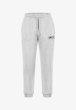 Pantaloni da tuta grigi in cotone con vita elasticizzata, cordino e caviglie elastiche. Presentano la scritta nera "SMILOOD" di lato.