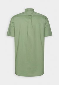 Chemise à manches courtes vert clair vue de dos avec un col boutonné et un pli central dans le dos.