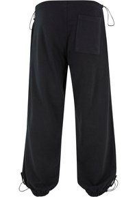 Sorte sweatpants lavet af et blødt stof, med en løs pasform, elastiske ribkanter, en baglomme og justerbare snore i taljen.