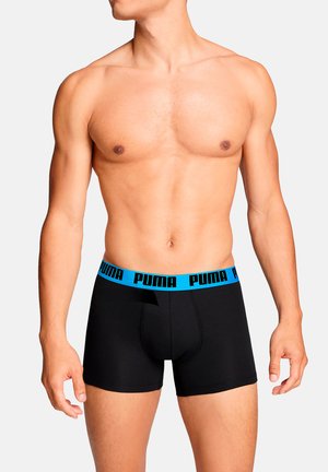 Black boxer briefs with a blue elastic waistband featuring "PUMA" printed in black. Smooth fabric, fitted design, and a front opening.