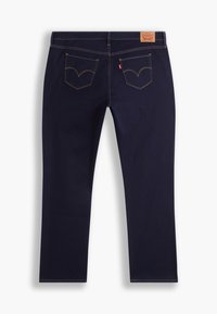 Mörkblå jeans med rak bendesign, som har två bakfickor med böjda sömmar och en läderlapp på midjebandet.