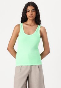 Mint green ribbed tank top with a scoop neckline and wide straps, featuring a fitted silhouette and soft texture.