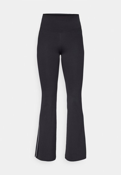 Black flared leggings with a high waist, made from stretchy fabric. Features a smooth texture and white side stripes along the seams.