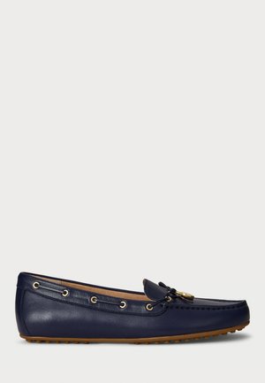 Navy leather loafers with a rounded toe, gold hardware, and decorative lacing. Rubber sole with small traction dots. Smooth texture.