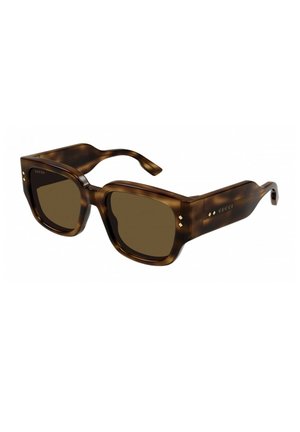 Occhiali da sole tartaruga marrone con montatura quadrata e lenti marroni. Presentano dettagli in metallo sul fronte e sulle aste, con logo del marchio sul lato.