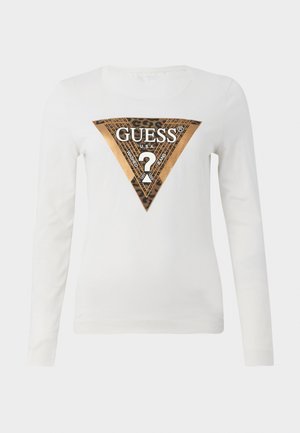 Valge pikakäistega särk, millel on suur metallik kuldne ja leopardimustriga kolmnurkne Guess logo ning tekst "GUESS U.S.A." keset rinda.