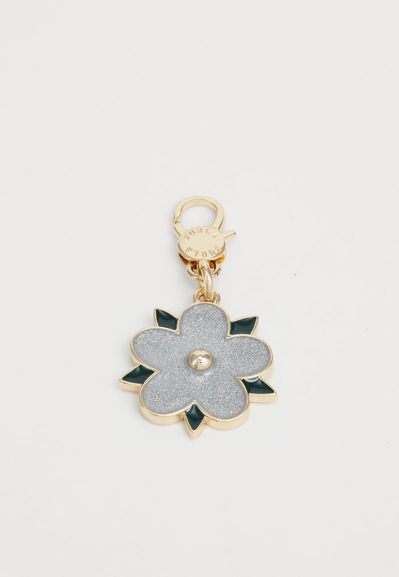 Porte-clés en forme de fleur dorée avec des pétales en paillettes argentées, des feuilles vert foncé, et un fermoir gravé du mot "Furla".