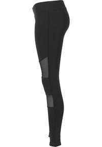 Leggings neri caratterizzati da un tessuto morbido, una vita alta e pannelli in rete sui lati per traspirabilità e contrasto di design.