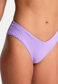 Lavender bikini bottom with a low-rise V shape, soft fabric texture, minimal seams, and smooth edges designed for comfort.