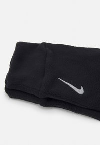 Czarna opaska na głowę z polaru złożona w stylu, z kontrastowym szarym logo Nike wyszytym z przodu. Miękka tekstura.