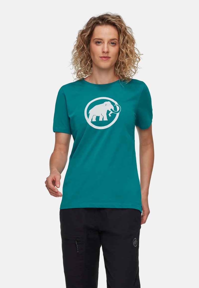 Teal kortärmad t-shirt i mjukt tyg med en stor vit grafik av en mammut inom en cirkel på framsidan.